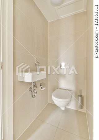 A sleek, modern bathroom featuring neutral tones, minimalist design, and contemporary fixtures. The layout emphasizes cleanliness and simplicity. 123353511