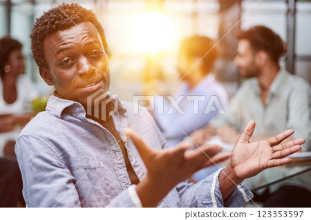 smiling African American business man with executives working in background 123353597