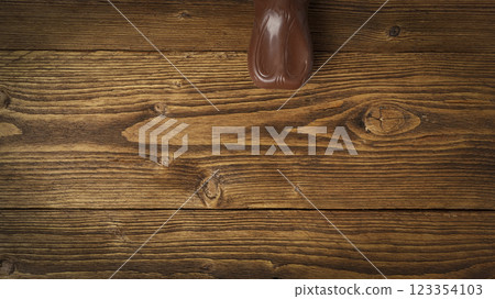 Easter chocolate bunny ears on wooden background Easter chocolate bunny ears on wooden background 123354103