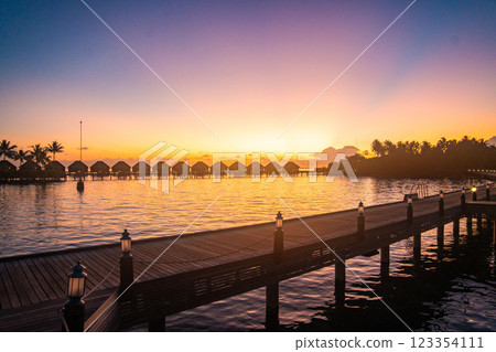 Sunset views from overwater pool villa in Maldives 123354111