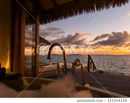 Sunset views from overwater pool villa in Maldives Sunset views from overwater pool villa in Maldives 123354139