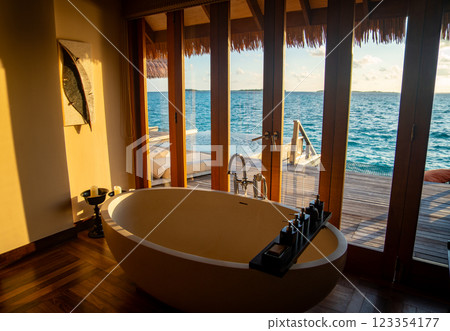 Sunset views from overwater pool villa in Maldives Sunset views from overwater pool villa in Maldives 123354177
