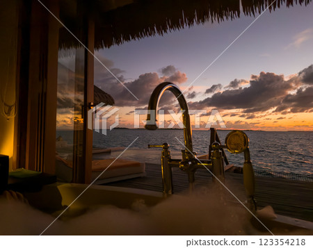 Sunset views from overwater pool villa in Maldives Sunset views from overwater pool villa in Maldives 123354218