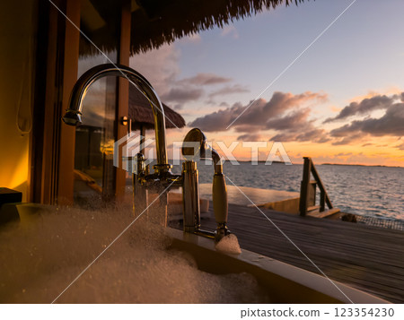 Sunset views from overwater pool villa in Maldives Sunset views from overwater pool villa in Maldives 123354230