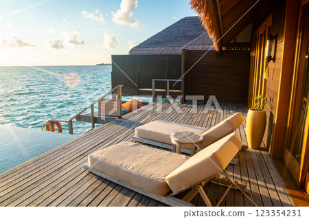 Sunset views from overwater pool villa in Maldives Sunset views from overwater pool villa in Maldives 123354231