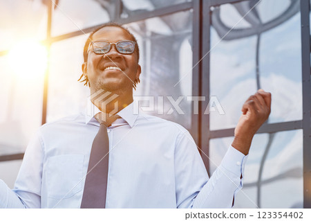 man in a modern office listening to music with white headphones 123354402