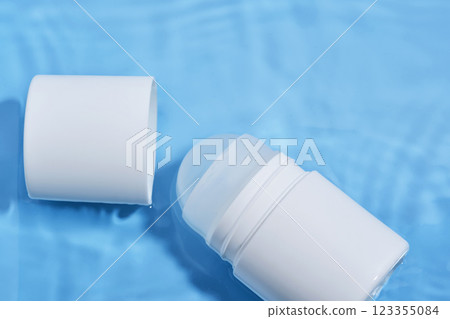 Roll-on deodorant on a blue background in water. 123355084