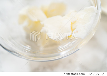 The vegetable shortening is expertly melted for greasing the bundt cake pan, setting the stage for baking this delicious cake. The vegetable shortening is expertly melted for greasing the bundt cake pan, setting the stage for baking this delicious cake. 123355134