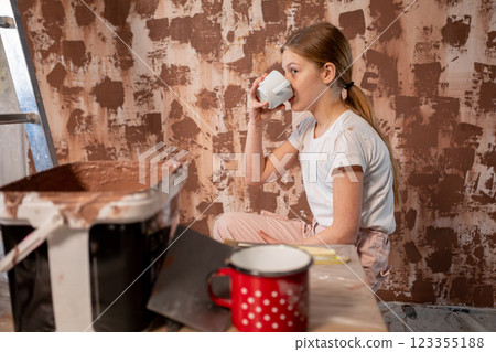 A Young Girl Enjoying a Relaxing Break While Engaged in Her Beautiful Painting Activity A Young Girl Enjoying a Relaxing Break While Engaged in Her Beautiful Painting Activity 123355188