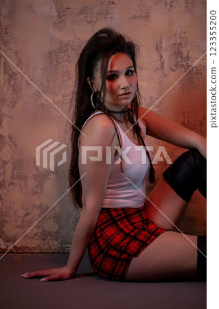 An Edgy Fashion Model is Confidently Posing in a Trendy Urban Setting, Showcasing a Unique Style 123355200