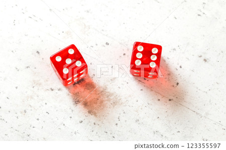 Two red craps dices showing Yo (Yo-leven) (number 5 and 6) overhead shot on white board 123355597