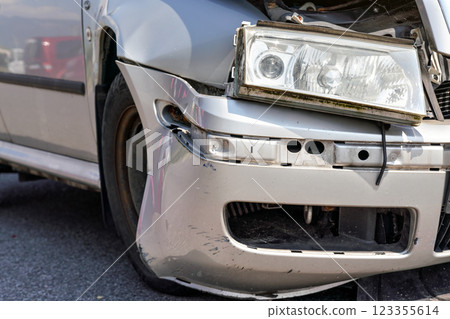Closeup of broken headlight on crashed car after road accident 123355614