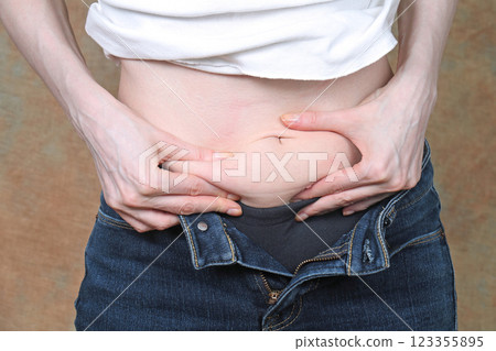 Holding belly fat 123355895