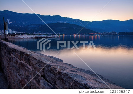 Evening reflections on the tranquil Budva harbor as the light fades. 123356247
