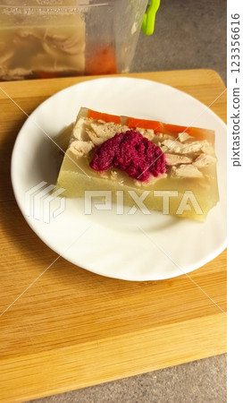 Traditional jellied meat dish served on a white plate Traditional jellied meat dish served on a white plate 123356616
