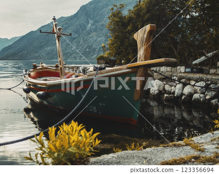 Wooden Boat Docked by Scenic Lakeside by Adriatic sea in the Kotor bay 123356694
