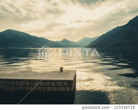 Peaceful Dock by Mountain Lake or Adriatic Fjord in Montenegro at Sunset  123356719