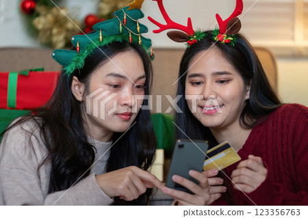 Happy Lesbian Couple Enjoying Christmas Shopping Together with Smartphone and Credit Card 123356763