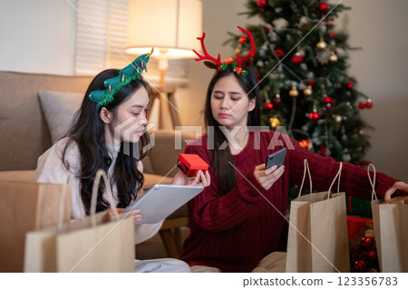 Thoughtful Lesbian Partners Engaging in Christmas Gift Selection and Planning Thoughtful Lesbian Partners Engaging in Christmas Gift Selection and Planning 123356783