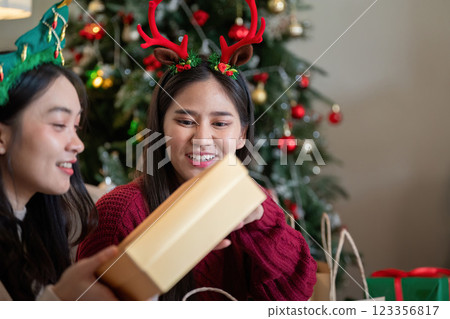 Diverse Friends Relishing Holiday Season with Gift Exchange 123356817