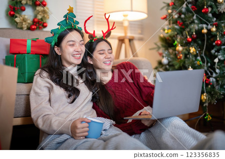 Lesbian Couple Enjoying Virtual Holiday Cheer Together 123356835