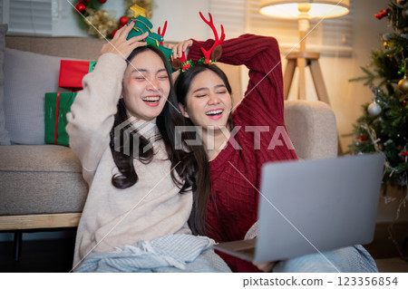 Lesbian Couple Relishing in Holiday Laughter and Connection 123356854