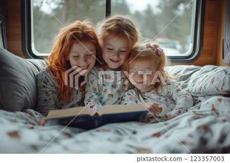 A mother and her two red-haired daughters share a joyful story A mother and her two red-haired daughters share a joyful story 123357003