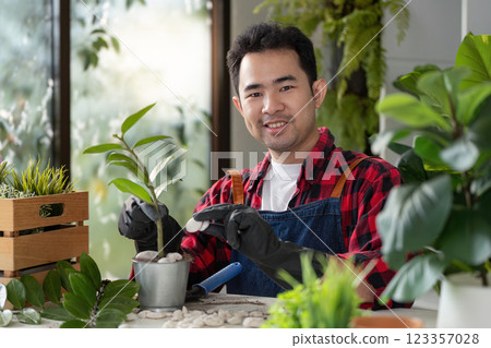 Cheerful Gardener Engaging with Plants for Vibrant Growth 123357028