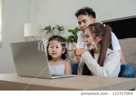 Family watching a movie together, sharing smiles and joy. 123357069