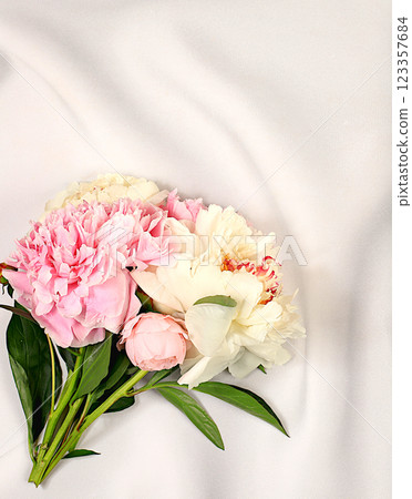 Bouquet of fresh peonies on sunny background.Abstract floral arrangement.Banner for congratulations on Mother's Day, wedding, Women's Day, birthday. Minimal modern aesthetics, elegant beauty concept Bouquet of fresh peonies on sunny background.Abstract floral arrangement.Banner for congratulations on Mother's Day, wedding, Women's Day, birthday. Minimal modern aesthetics, elegant beauty concept 123357684
