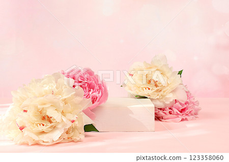 Abstract background with empty podium and peonies flowers, empty showcase for display or presentation of cosmetic products, Minimal floral arrangement card with place for text, selective focus Abstract background with empty podium and peonies flowers, empty showcase for display or presentation of cosmetic products, Minimal floral arrangement card with place for text, selective focus 123358060