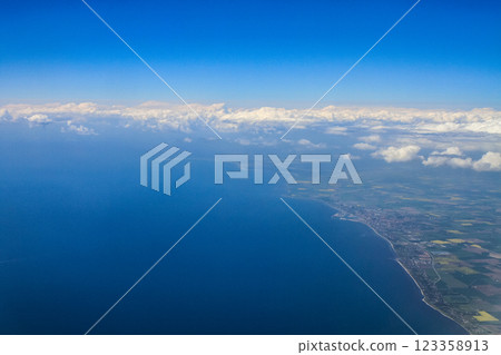 beautiful thick clouds in the sky from the height of the flight of the plane with a view of the continent and countries 123358913