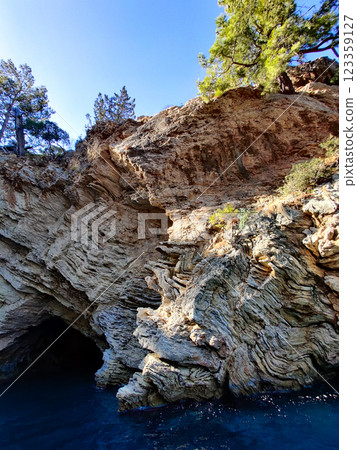 a large cave on the seashore is washed by water 123359127