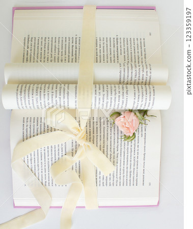 a beautiful arrangement of a bouquet of roses and a book 123359197
