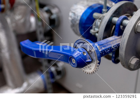 CloseUp of a Blue Valve Handle in Industrial Settings, highlighting its significance and function 123359291
