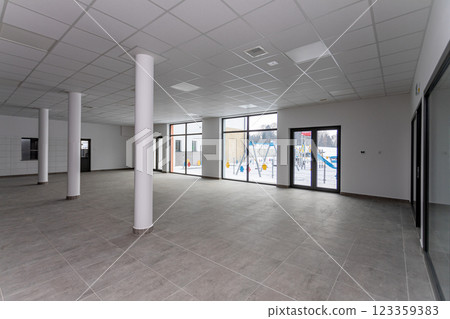 A Spacious Empty Commercial Space Featuring Large Windows That Provide Abundant Natural Light 123359383
