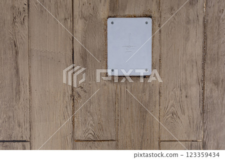 A modern wall plate on rustic wood creates a striking contrast, enhancing aesthetic appeal 123359434