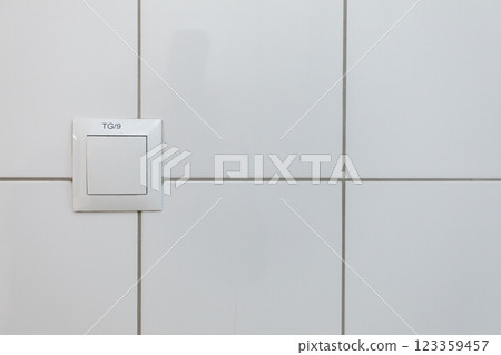 A clean white wall featuring a switch plate accentuates a minimalist and modern design A clean white wall featuring a switch plate accentuates a minimalist and modern design 123359457