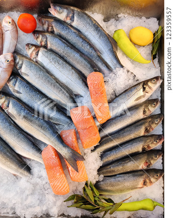 many different fresh seafood fish on the counter in the store 123359557