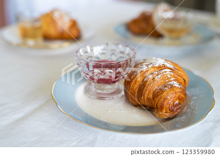 delicious fresh croissant on a plate at the table 123359980