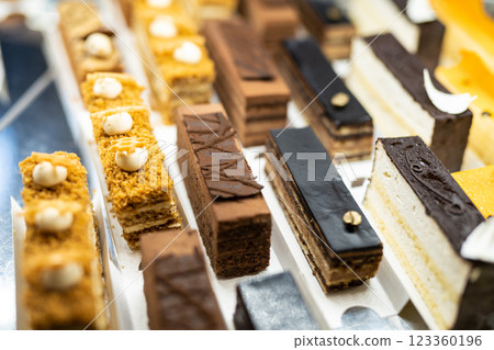 various delicious sweet pastries in the shop window. 123360196