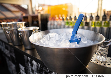 an ice bucket with a spatula in a restaurant for cooling drinks 123360200