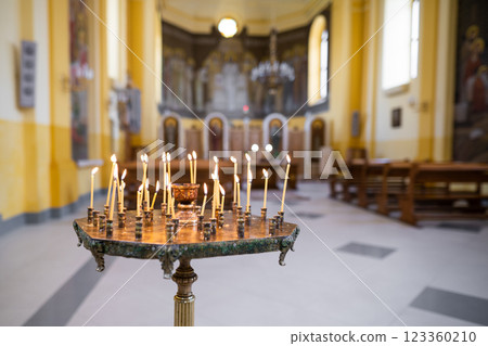 candles burn beautifully on a stand in the church 123360210