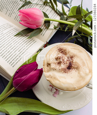 a beautiful arrangement of a bouquet of tulips and a book with a cup of coffee 123360284