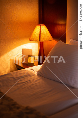 a beautiful photo of a bedside lamp in a hotel room 123360286