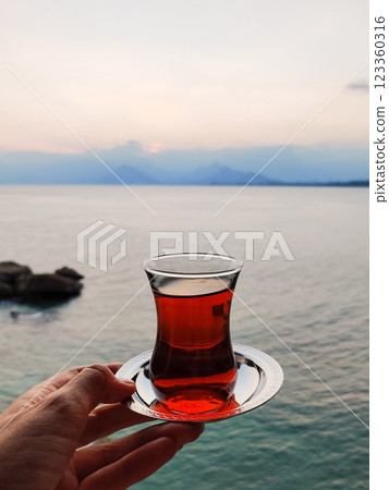 transparent cup of turkish black tea on the sea 123360316