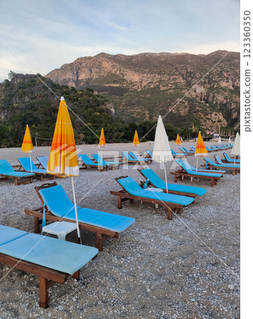 deck chairs and umbrellas on the sea beach in summer deck chairs and umbrellas on the sea beach in summer 123360350