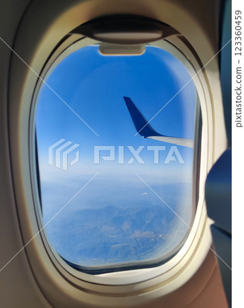 sky from the height of the flight of the plane in round window 123360459