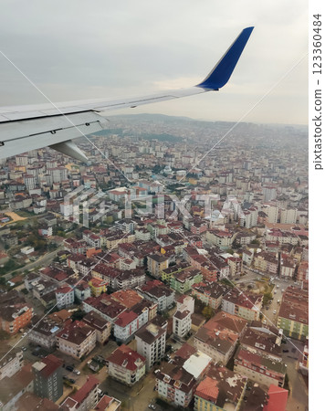 beautiful thick clouds in the sky from the height of the flight of the plane with a view of the wing with engines 123360484
