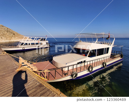 beautiful ships and boats are moored near the shore beautiful ships and boats are moored near the shore 123360489